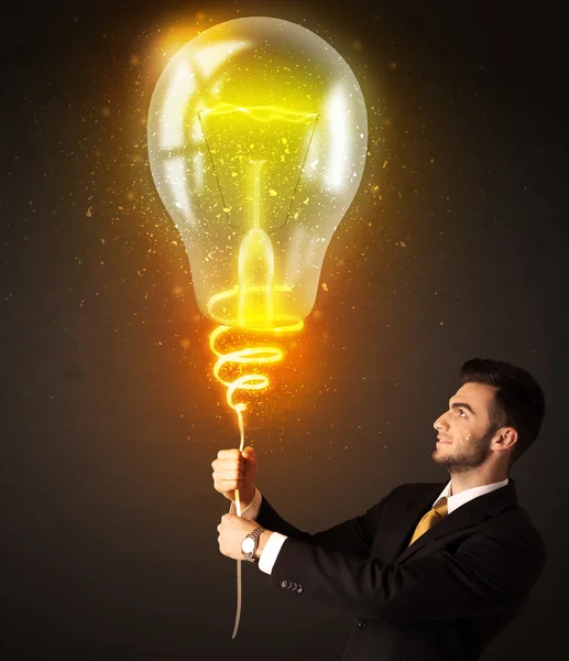 Businessman with an idea bulb — Stock Photo, Image