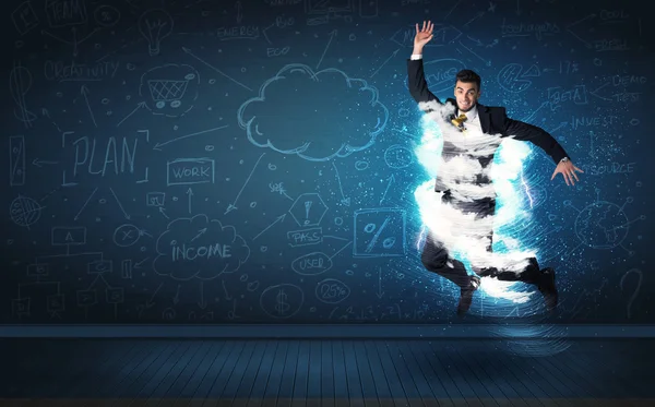 Happy business man jumping with storm cloud around him — Stock Photo, Image