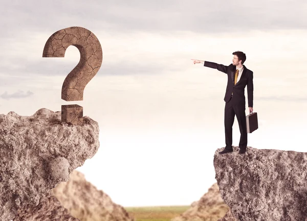 Businessman on rock mountain with a question mark — Stock Photo, Image