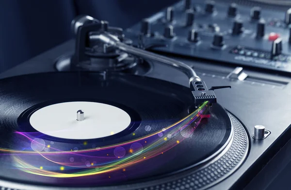 Turntable playing vinyl with glowing abstract lines — Stock Photo, Image