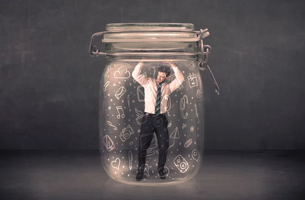 Business man captured in glass jar with hand drawn media icons c — Stock Photo, Image