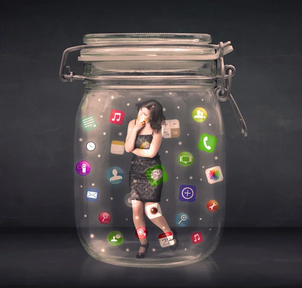 Businesswoman captured in a glass jar with colourful app icons c — Stock Photo, Image