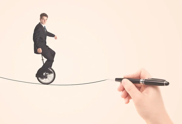 Businessman riding monocycle on a rope drawn by hand — Stock Photo, Image