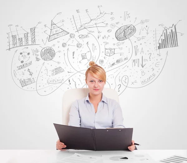 Business woman at desk with hand drawn charts — Stock Photo, Image