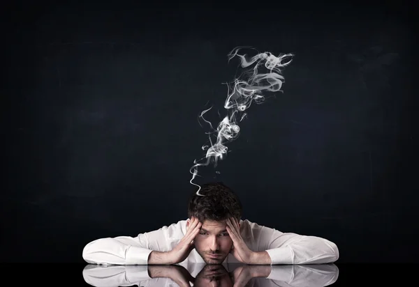 Depressed businessman with smoking head — Stock Photo, Image