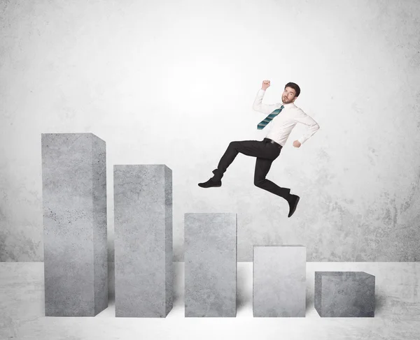Successful business man jumping over charts on background — Stock Photo, Image