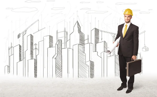 Engineer man with building city drawing in background — Stock Photo, Image