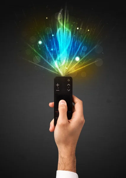 Hand with remote control and explosive signal — Stock Photo, Image