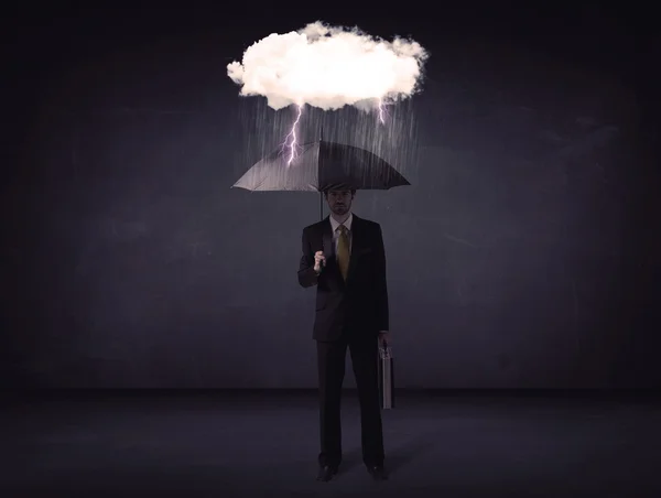 Businessman standing with umbrella and little storm cloud — Stock Photo, Image