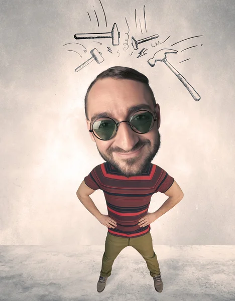 Big head person with drawn hammers — Stock Photo, Image