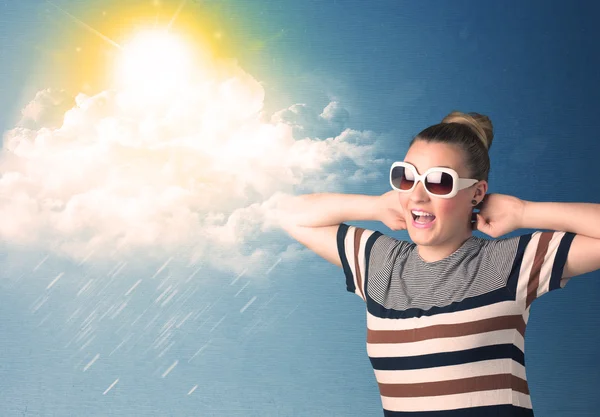 Young person looking with sunglasses at clouds and sun — Stock Photo, Image