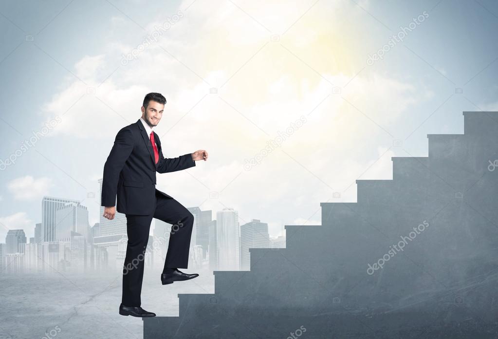 Businessman climbing up a concrete staircase concept
