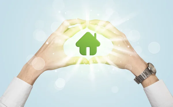 Hands creating a form with green house — Stock Photo, Image