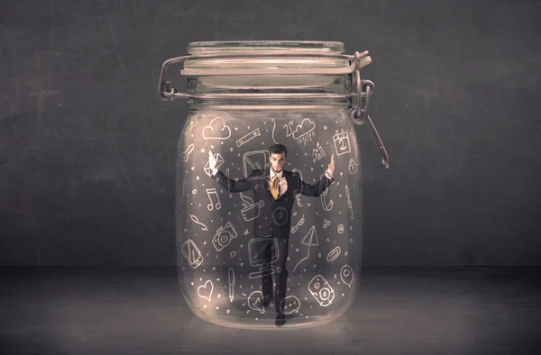 Business man captured in glass jar with hand drawn media icons c — Stock Photo, Image