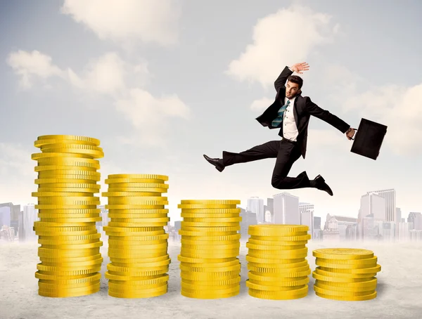 Successful business man jumping up on gold coin money — Stock Photo, Image