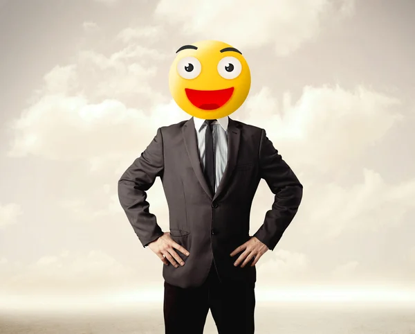 Businessman wears yellow smiley face Royalty Free Stock Photos