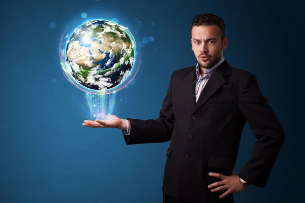 Businessman holding glowing earth globe — Stock Photo, Image