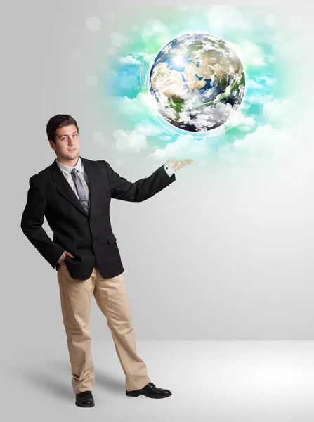 Young man with earth and cloud concept — Stock Photo, Image