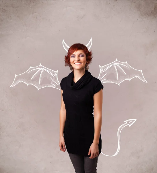 Young girl with devil horns and wings drawing — Stock Photo, Image