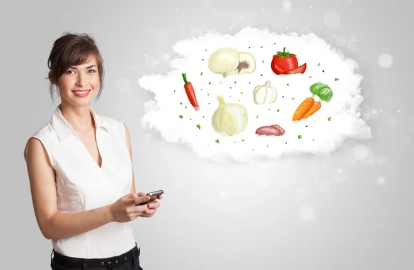 Pretty woman presenting a cloud of healthy nutritional vegetable — Stock Photo, Image