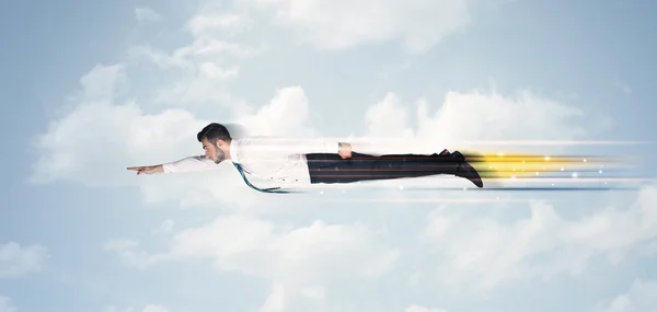 Happy business man flying fast on the sky between clouds — Stock Photo, Image