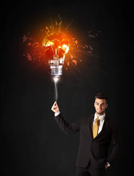 Businessman with an explosion bulb — Stock Photo, Image