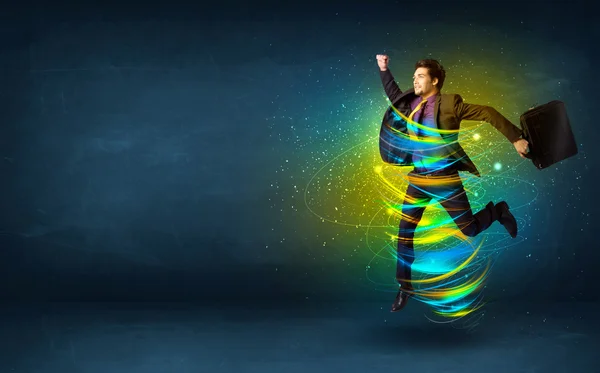 Emocionado hombre de negocios saltando con líneas de colores de energía — Foto de Stock