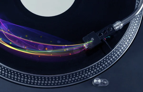 Turntable playing vinyl with glowing abstract lines — Stock Photo, Image