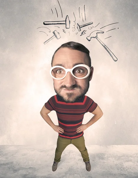 Big head person with drawn hammers — Stock Photo, Image