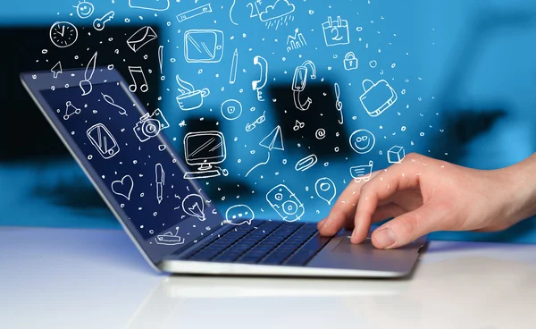 Laptop computer wtih hand drawn icons and symbols — Stock Photo, Image