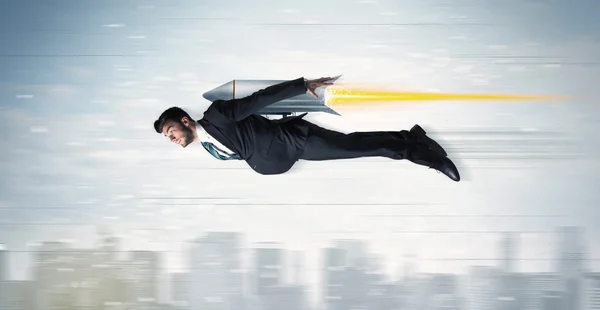 Superhero business man flying with jet pack rocket above the cit — Stock Photo, Image