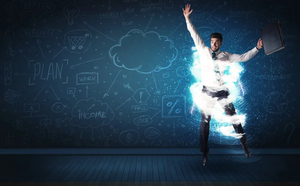 Happy business man jumping with storm cloud around him — Stock Photo, Image