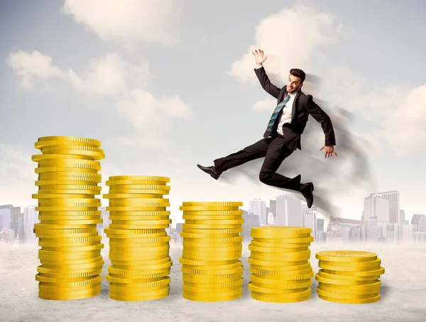 Successful business man jumping up on gold coin money — Stock Photo, Image