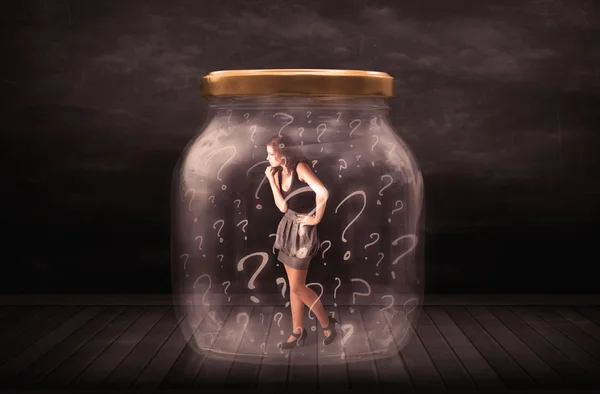 Businesswoman locked into a jar with question marks concept — Stock Photo, Image