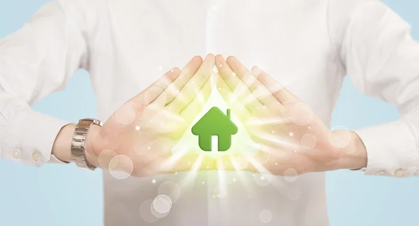 Hands creating a form with green house — Stock Photo, Image