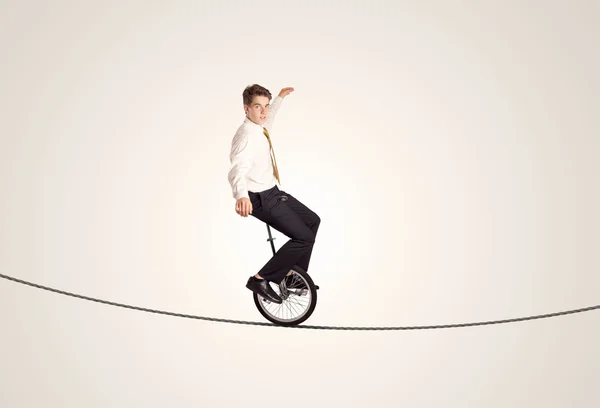 Extreme business man riding unicycle on a rope — Stock Photo, Image