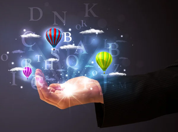 Letters and balloons in the hand of a businessman — Stock Photo, Image