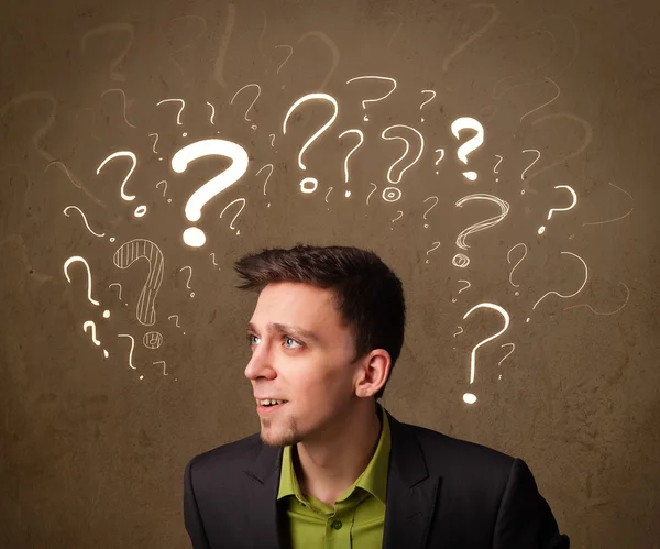 Man with question mark symbols around his head — Stock Photo, Image