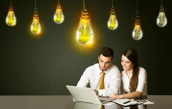 Business couple with idea bulbs — Stock Photo, Image