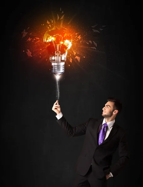 Businessman with an explosion bulb — Stock Photo, Image