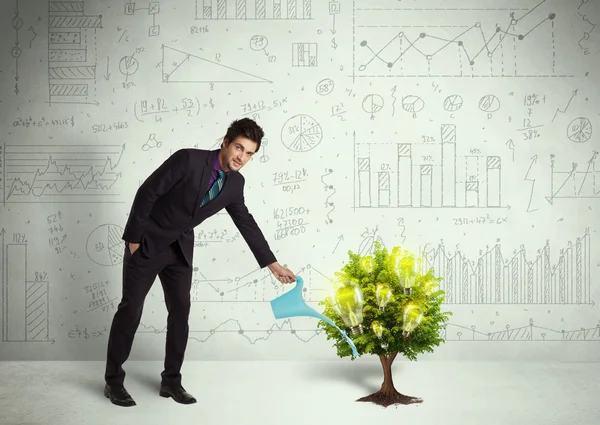 Business man pouring water on lightbulb growing tree — Stock Photo, Image