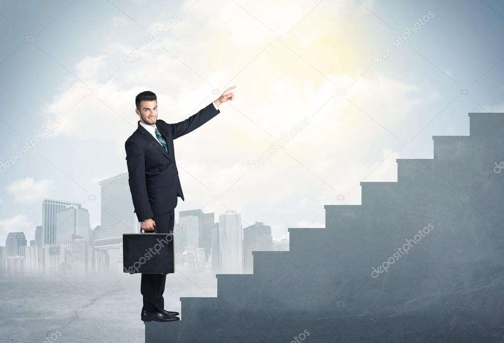 Businessman climbing up a concrete staircase concept