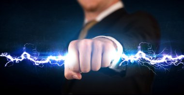 Business man holding electricity light bolt in his hands clipart