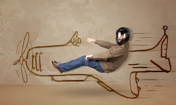 Funny pilot driving a hand drawn airplane on the wall — Stock Photo, Image