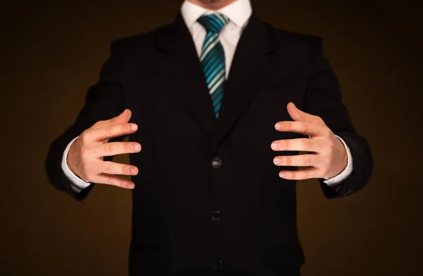 Businessman holding something — Stock Photo, Image