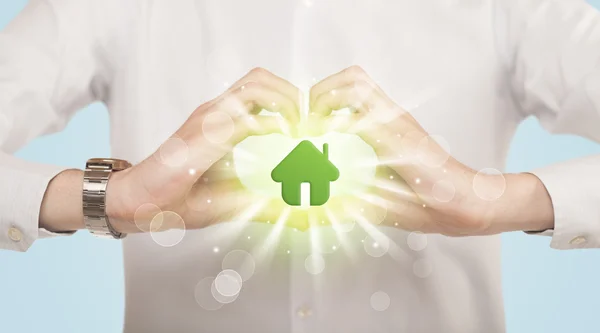 Hands creating a form with green house — Stock Photo, Image