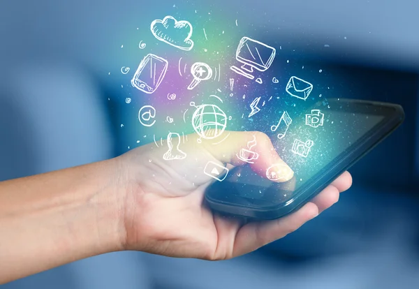 Hand holding smartphone with media icons — Stock Photo, Image