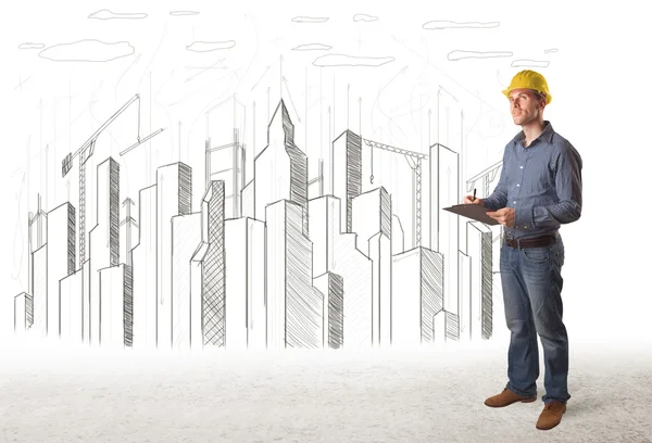 Engineer man with building city drawing in background — Stock Photo, Image