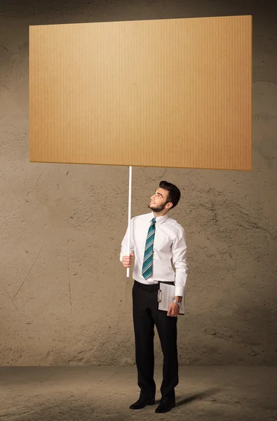 Businessman with blank cardboard — Stock Photo, Image