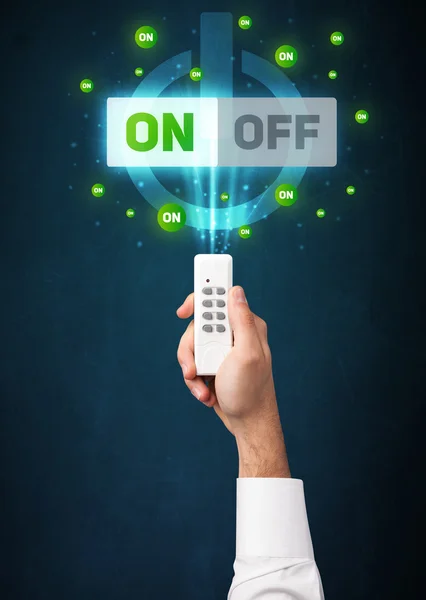 Mano con telecomando e segnali on-off — Foto Stock